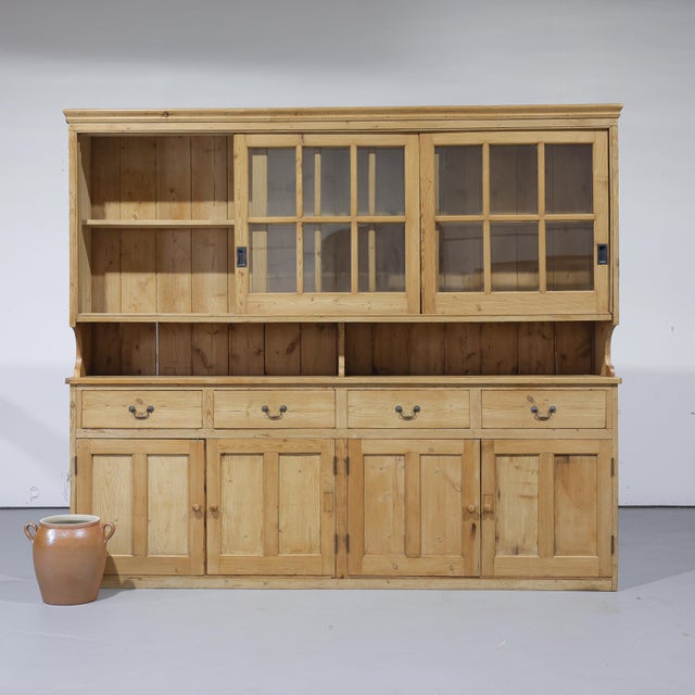 A substantial antique pine dresser offering an incredible amount of storage and display space. The upper section features...