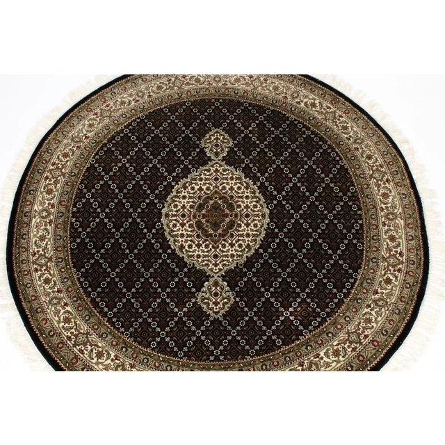 This very elegant fine quality circular vintage Indian rug that dates from the last quarter of the 20th century. This...