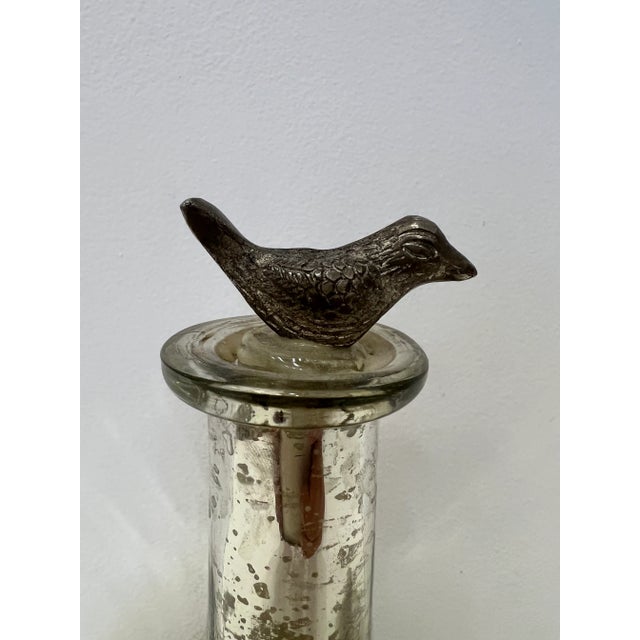For your consideration: Vintage mercury glass with a bird topper, nice worn patina on the glass.