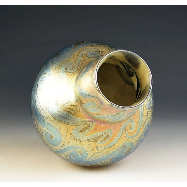 An exceptional early example of American Art Nouveau, this large Favrile glass vase was handcrafted at Tiffany Studios...