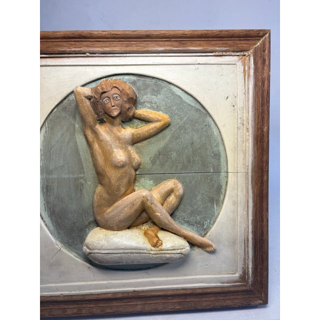 Studio craft relief carving of a nude woman in a seated, graceful pose. Hand carved with visible chisel marks and texture...