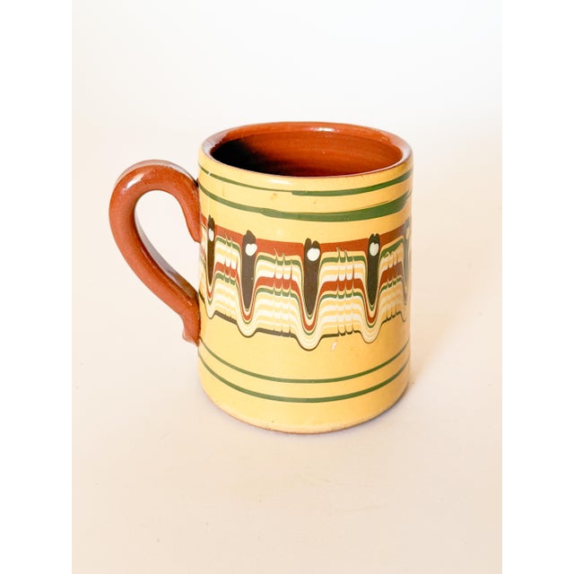 Charming handcrafted vintage Bulgarian Troyan Redware mug with feathered drip glaze in terra cotta brown, green, and...