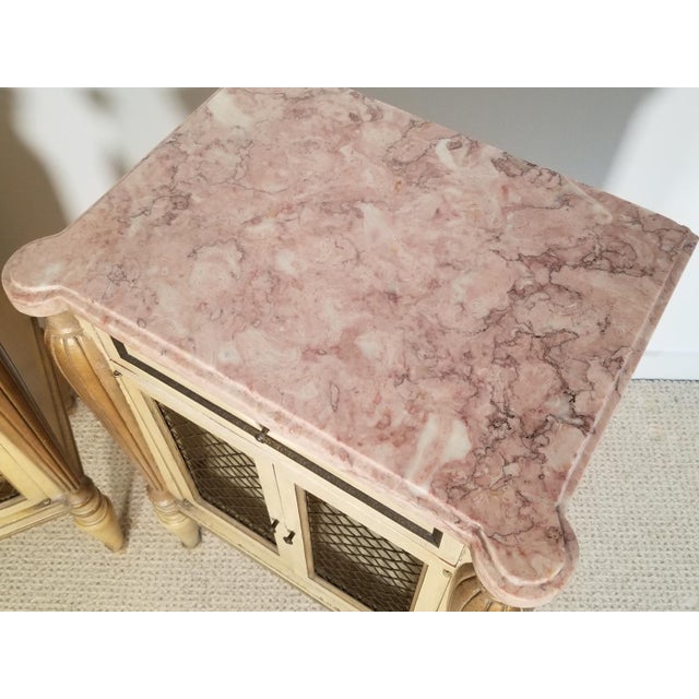 A pair of vintage marble top nightstands by Maslow Freen Furniture. Beautiful wire latticework on the doors. 20"L x 14"D x...