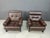 Pair of mid century brown leather armchairs with ebonized wooden frames. Very comfy pair of chairs. The cushions are...