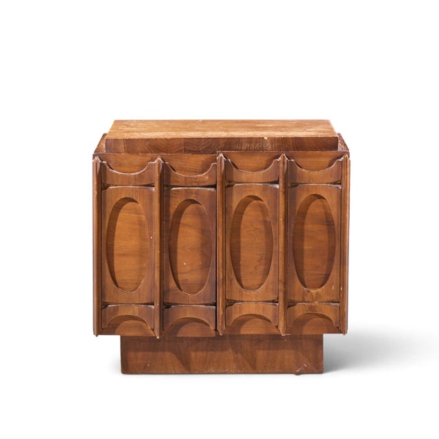 Tobago Brutalist Mid Century Walnut Nightstand This nightstand measures: 26 wide x 18 deep x 24.75 inches high Fair...