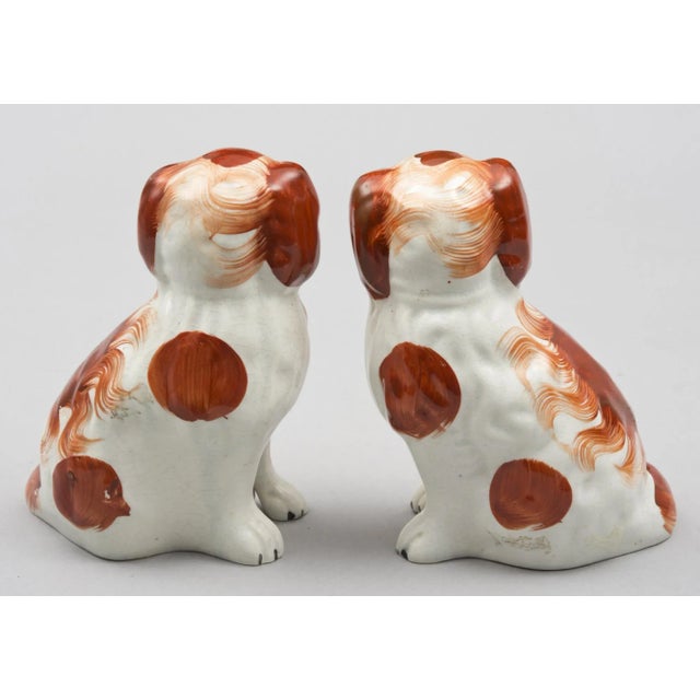 Pair of red Staffordshire style King Charles spaniels with separate front legs.