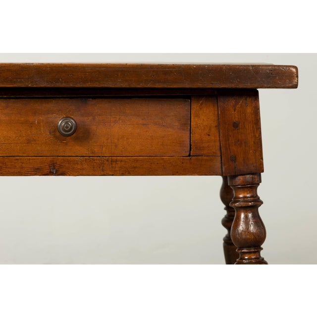 A late 19th-century French Provincial oak writing table or desk, sourced in Provence, France. Crafted from solid oak, the...