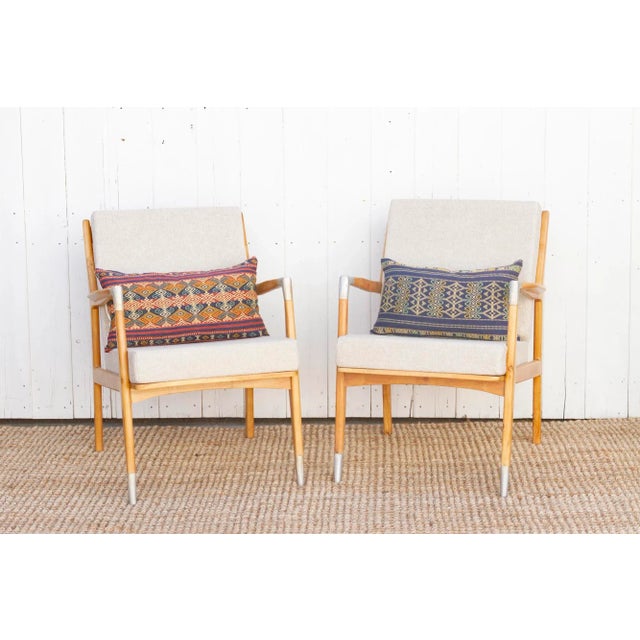 Embrace the timeless style of mid-century modern design with this captivating pair of lounge chairs. Crafted from solid...