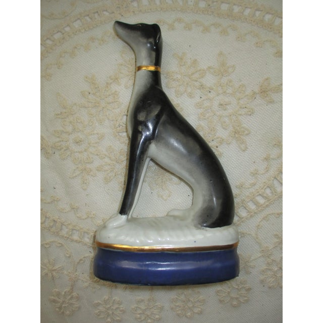 This is a Gorgeous Elegant Antique Whippet Dog on a Blue & White Pillow Figurine that is a Dark Grey and White Whippet Dog...