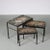 A lovely set of 3 nesting tables, manufactured in the netherlands around 1960. each table has a straight, black lacquered...