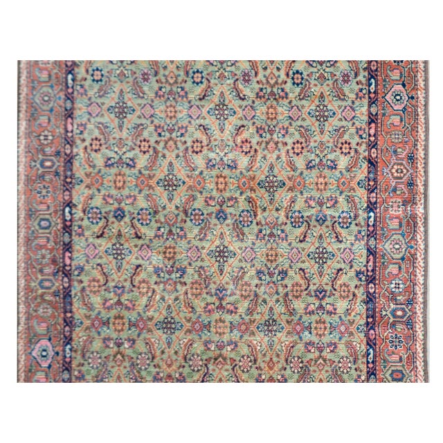 A beautiful early 20th century Persian Sultanabad rug with an all-over trellis floral and leaf pattern woven in orange,...