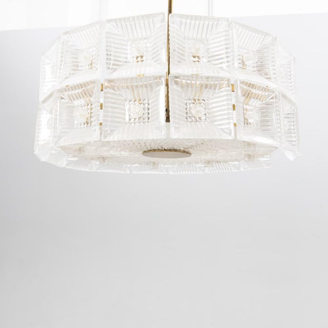 Carl Fagerlund, a glass and brass double disk ceiling pendant for Orrefors later part of the 20th century. For six light...