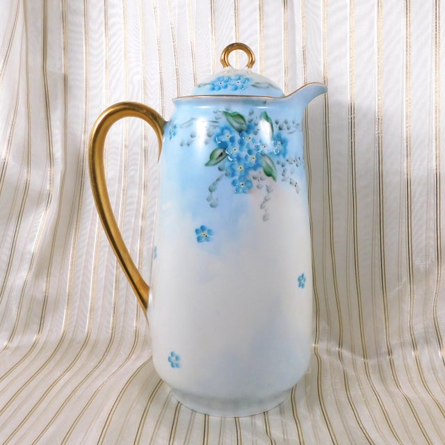 This is a signed chocolate or coffee pot. It is signed on the base and marked Germany as shown. It is white with blue and...