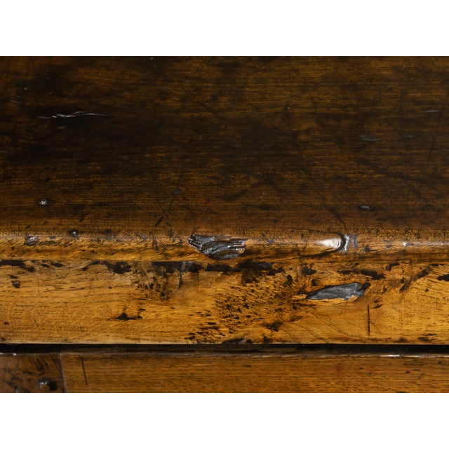 An English early oak cupboard from the 18th century, with rustic appearance, two doors, carved panels and distressed...