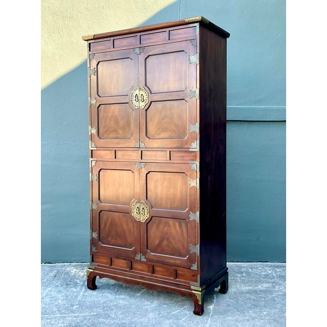 This stately armoire by the renowned furniture maker Henredon is a striking example of Asian Modern design, masterfully...