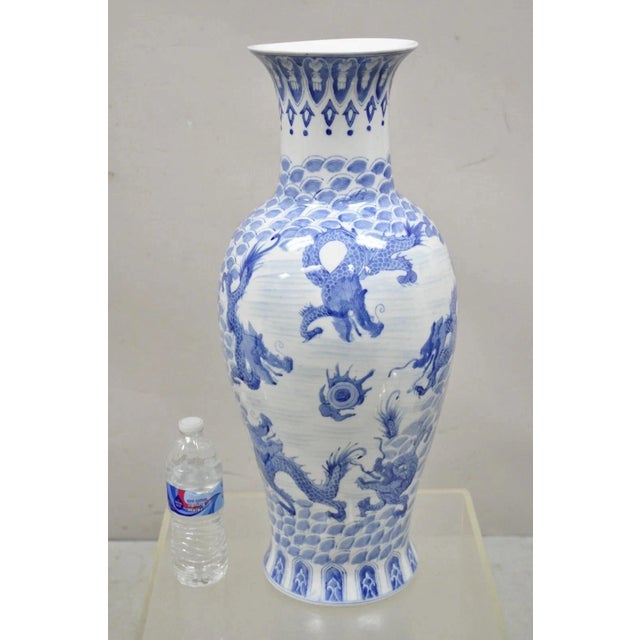 Vintage Chinese Export Delf Style Blue and White Porcelain 25" Tall Dragon Vase. Item features a delf blue dragon design...