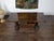 An Italian walnut table from the 19th century, with trestle base, turned legs, cross stretcher and single drawer. Created...