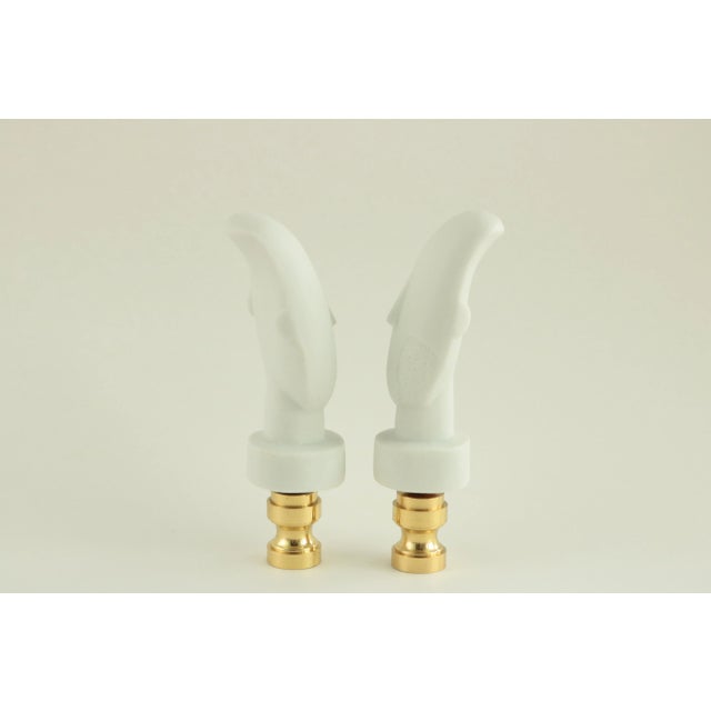 Pair of matching lamp finials crafted from porcelain figures modeled after a piece held in the collection of the Louvre:...