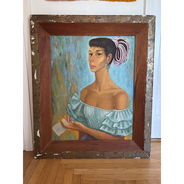 A striking portrait featuring a woman in an off-the-shoulder ruffled blue dress and silver earrings. She is holding a...