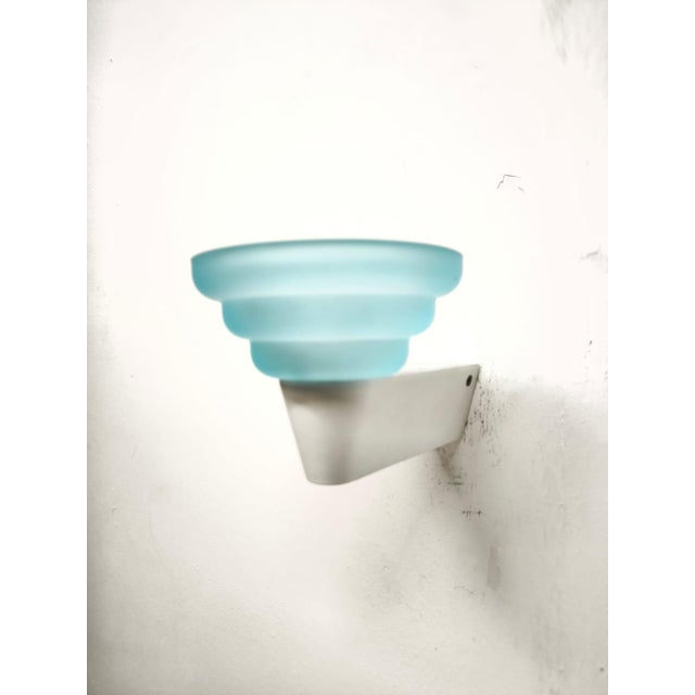 Light Blue Glass Wall Lamp from Leucos, 1980s, in Very Good conditions. Designed 1980 to 1989 This piece has an...