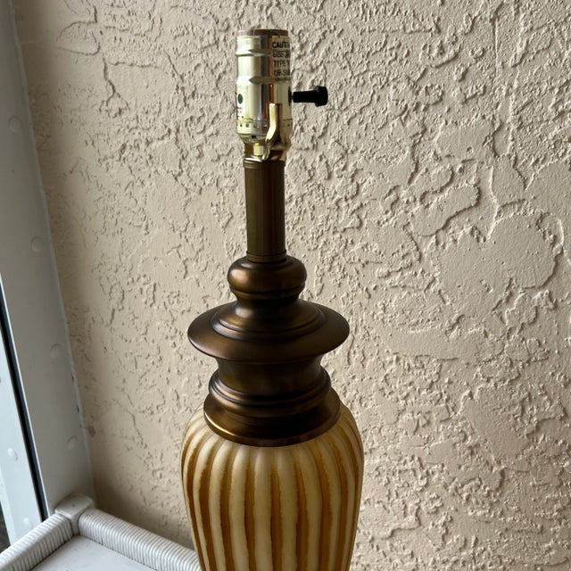 Beautiful pair of table lamps. 25” tall. Base is 7” in diameter. Frosted glass and rubbed body approximately 12” high and...