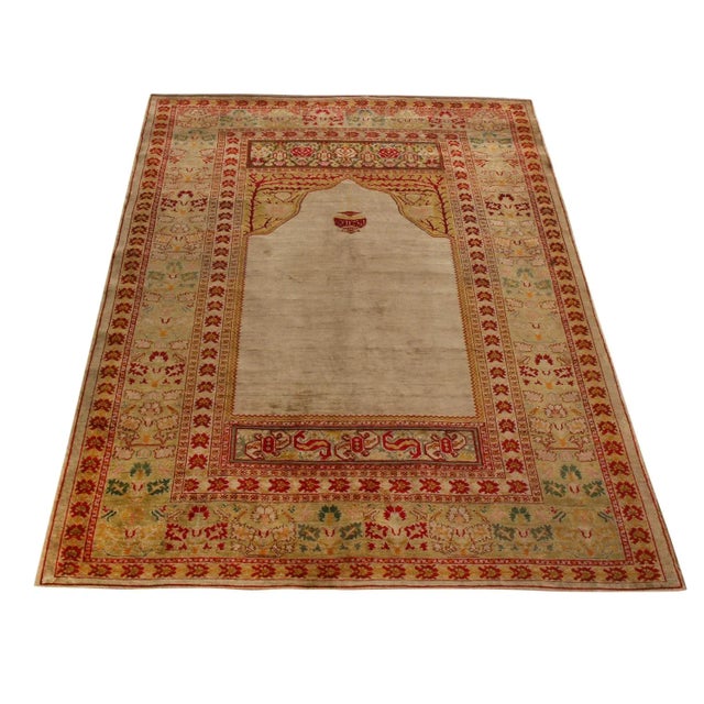 Dancing curvilinear patterns paired with a classic sense of eastern symmetry lend this antique Hereke rug tones of...