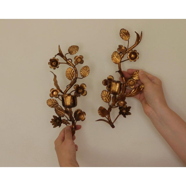 Made in Italy A charming pair of Italian sconces crafted from gilded metal, resembling leaves and flowers. Both sconces...