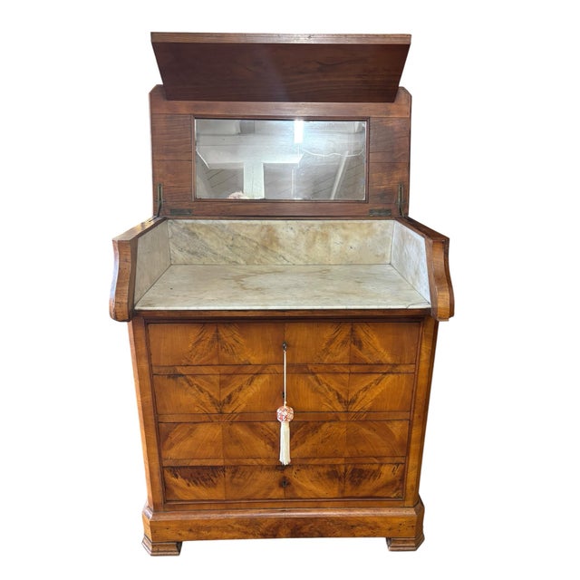 Beautiful Beidermeier walnut washstand featuring striking flame Walnut veneers, a lift top lid which slides forward when...