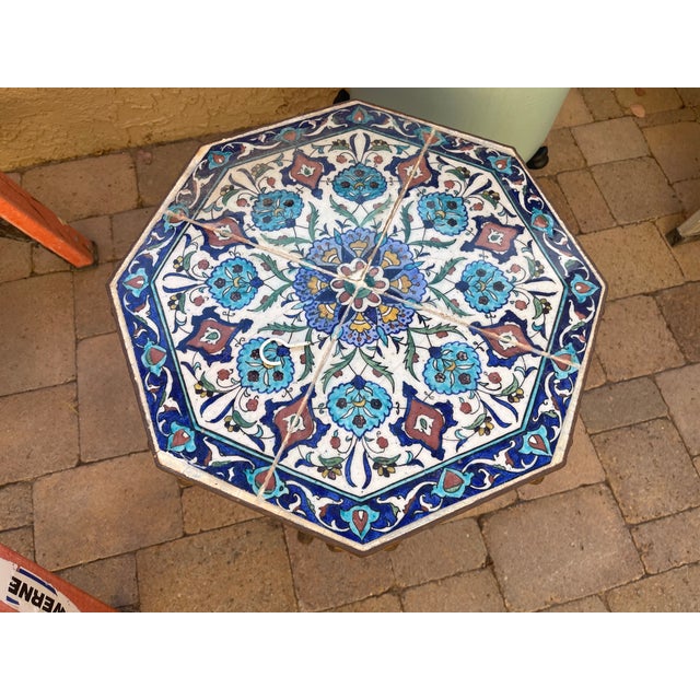 California Yellin School plant stand features wrought iron base with tripod twist foliate and scroll form legs supporting...