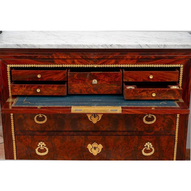 French Charles X chest of drawers in mahogany feather with white statuary marble top. The front is punctuated by three...