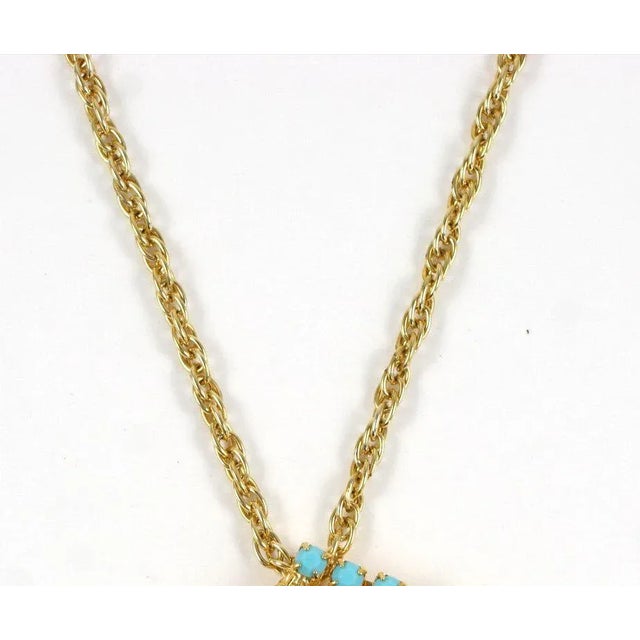 This is part of Chairish’s Costume Jewelry assortment. Gilt filigree head of Nefertitit embellished with faux turquoise...