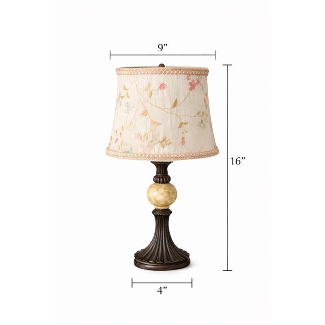 A charming decorative pair of petite table lamps distinguished by softly embroidered floral shades and classic bronze-tone...