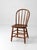 Classic Windsor chair with a warm, inviting presence. The curved hoop back and slender spindles create an open, airy...
