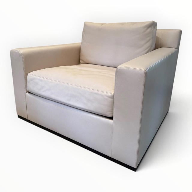 Ultra-comfortable club chairs from luxury furniture maker Holly Hunt. The Gryphon chair has been customized with a swivel...