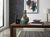 This striking ceramic vase features a bulbous body that tapers into a slender neck, beautifully finished in a glossy teal...