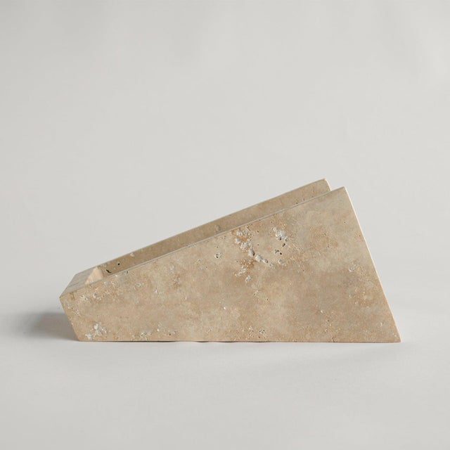 This travertine wine stand holds a single wine bottle in a clean, balanced position. The natural stone base supports the...