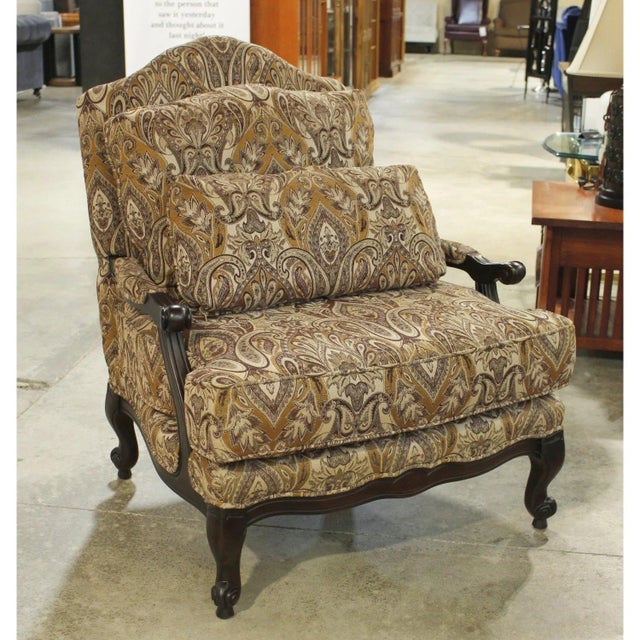 Traditional bergère styling is paired with an allover brown and gold paisley tapestry upholstery. The framed silhouette...