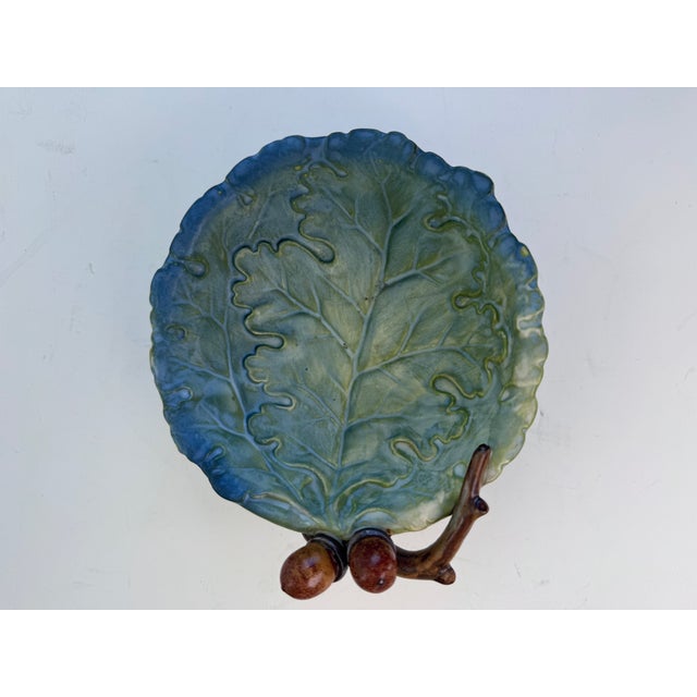 A delicately hand painted bowl made by Takahashi in Japan. It depicts a life size oak leaf and cluster of acorns. This...