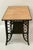 Dark brown painted wicker base with blond wood writing surface Braided wicker accent surrounds the top Woven wicker shelf...