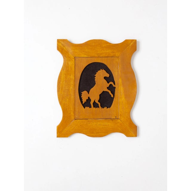 Offered is a vintage wood horse silhouette art in matching frame. The slender wood cut-out art features a horse against a...