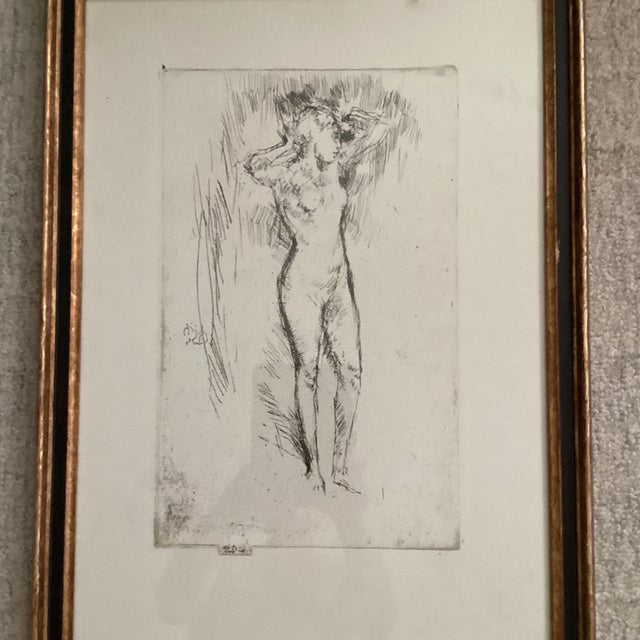 This art print features an etching with drypoint “binding the hair”, created by James McNeill Whistler during the period...