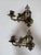 Design Plus Gallery presents a Pair of Antique Piano Sconces of Brass. This pair of reticulating armed sconces has a...