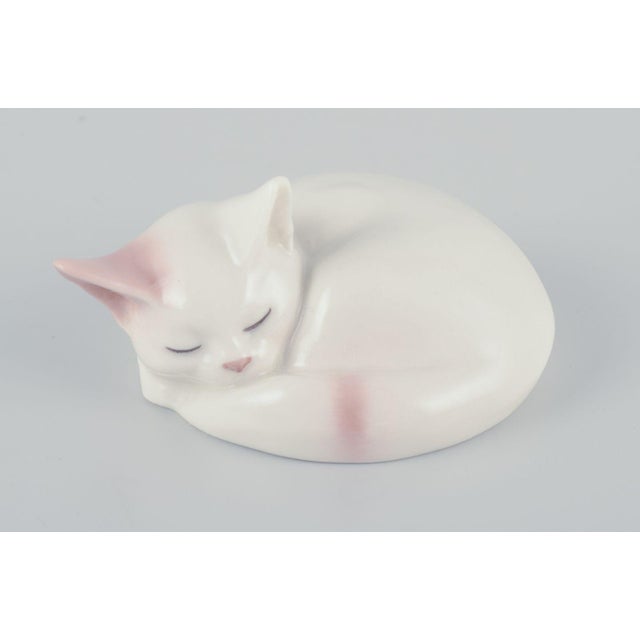 Royal Copenhagen mini collection. Two porcelain figurines of a sleeping kitten and a figurine of playing kittens. Model:...