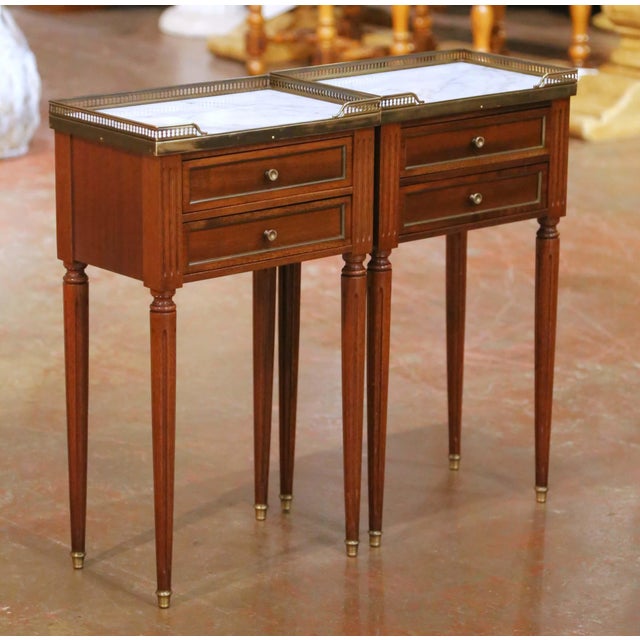 Decorate a bedroom or living room with this elegant pair of antique French Louis XVI style nightstands. Crafted in France...