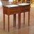 Decorate a bedroom or living room with this elegant pair of antique French Louis XVI style nightstands. Crafted in France...