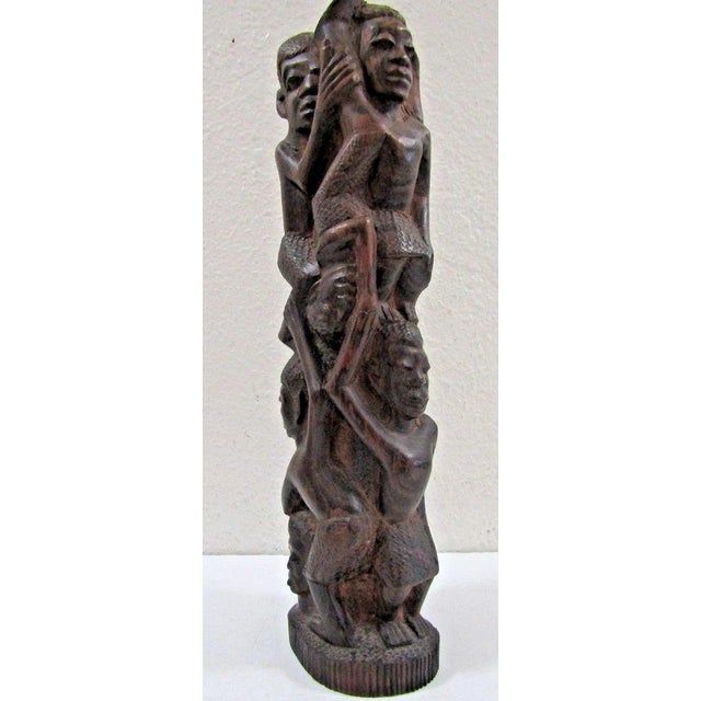 Vintage Makonde Tree of Life Ujamaa Wood Carving Sculpture Measures 4" wide, 3" deep and 13 3/4" tall. This is a...