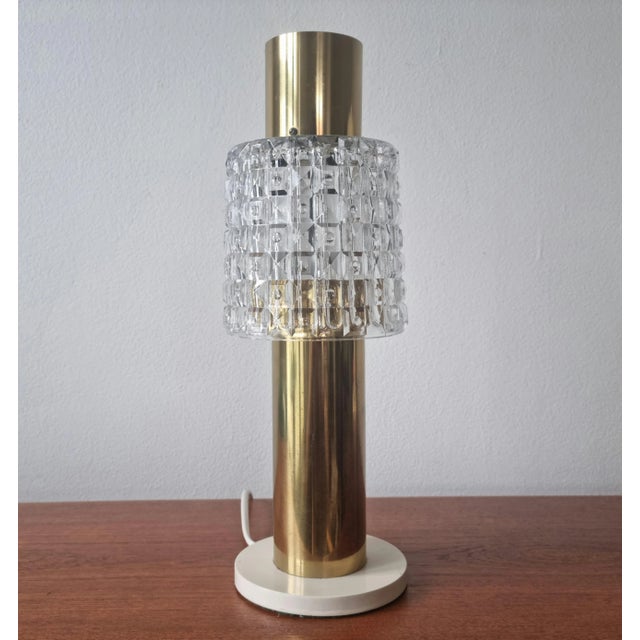 This is a very nice table lamp from a hotel. It is marked with a label. The table lamp is in good condition and wear is...