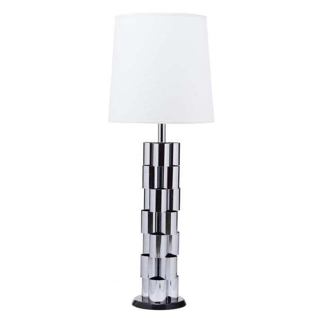 Large scale chrome curvy sculptural lamp on ebonized wood circular base. Retains partial paper label Mutual Sunset Lamp...