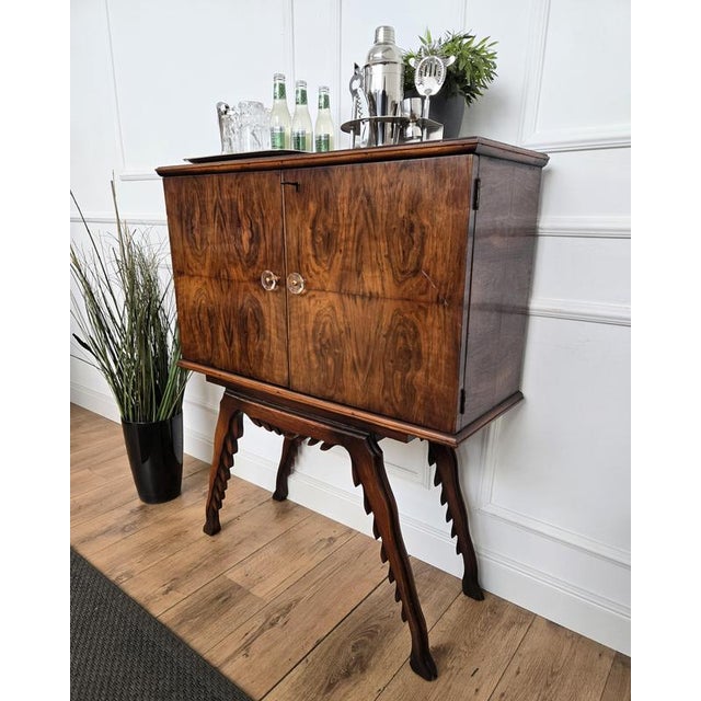 Impressive 1950s Italian sideboard bar cabinet in beautiful burl veneer wood, two front doors and standing on greatly...