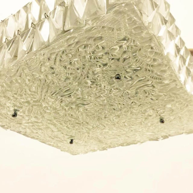 Crystal pendant lamp from the 1960s that features a steel construction with six lights and with 40x40cm art-glass plate as...